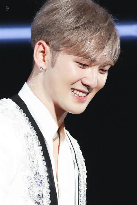 A Close Up Of A Person Wearing A White Shirt And Black Tie With A Smile