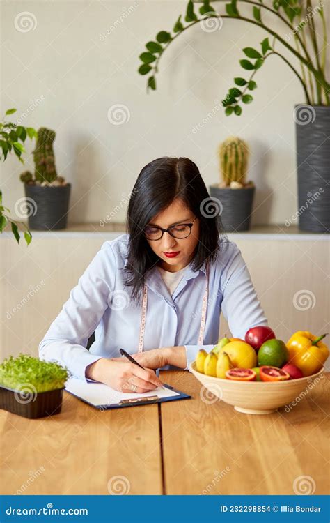 Nutritionist Dietitian Woman Writing A Diet Plan With Healthy