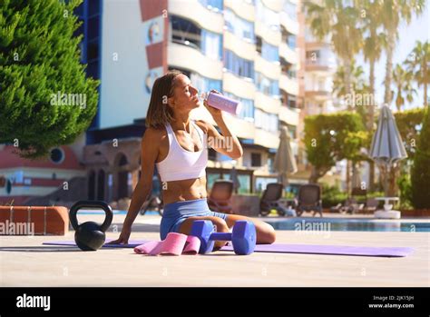 Tired Woman Having Rest After Workout Tired And Exhausted Female Athlete Sitting On Floor Near