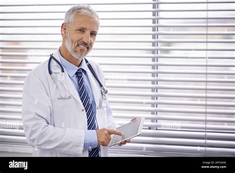 Using Tech To His Advantage In His Medical Practice Portrait Of A Mature Male Doctor Using A