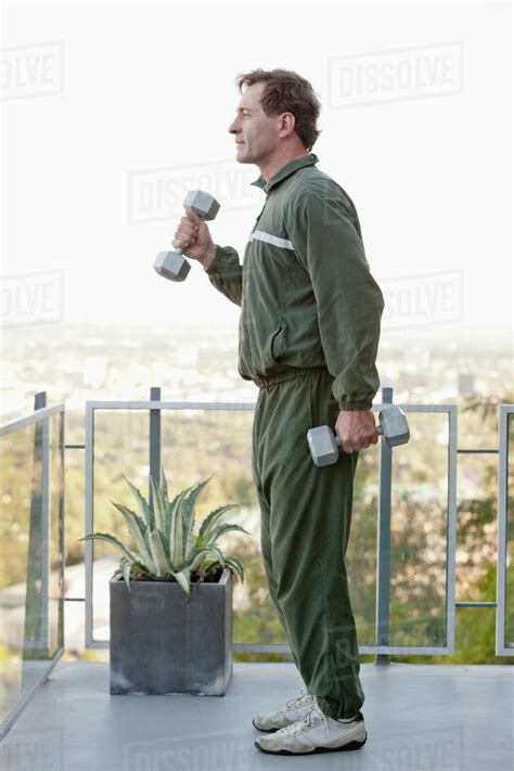 Mature Man Exercising On Balcony Royalty Free Stock Photo Dissolve