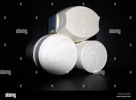 Child Proof Packaging On The Lids Of Pill Bottles Photographed Against