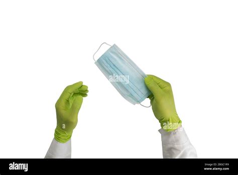 Hands In Rubber Gloves Hold A Protective Medical Mask Surgical Mask