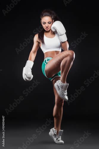 Beautiful Sexy Kickboxer Girl Dressed In Gloves And Taking Hit By Leg