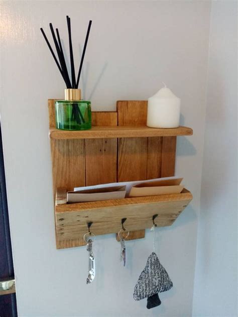 A Wooden Shelf That Has Some Items On It And Hanging From The Hooks In