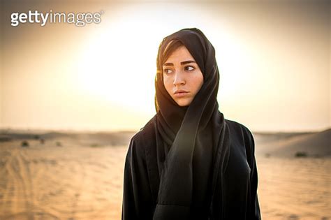 Portrait Of Beautiful Arab Woman In The Desert During Sunset