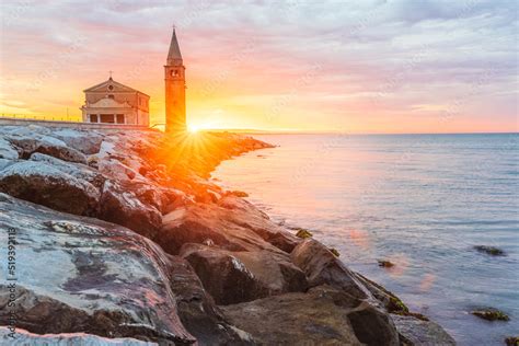 The City Of Caorle In Italy At Sunrise And Its Landmark On The Main