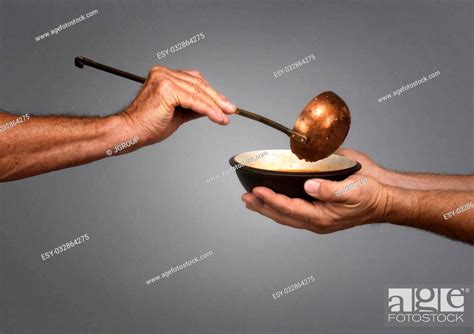 Man Holding A Bowl In Both Hands Receiving A Serving Of Soup From