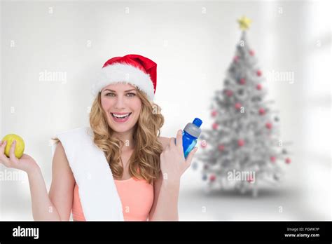 Composite Image Of Festive Fit Blonde Smiling At Camera Stock Photo Alamy