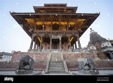 Statues Of Kneeling Elephants Guarding Brick And Wooden Temple In