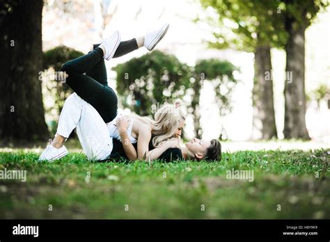 couple laying on the grass Stock Photo - Alamy