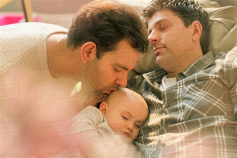 Affectionate Male Gay Parents Kissing Sleeping Baby Son Royalty Free Stock Photo Dissolve