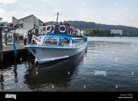 Tourists about to set off on a boat tour round Windermere in the Lake ...