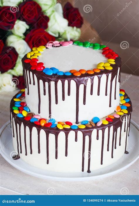 White Birthday Cake With Colorful Sprinkles Over A Light Background