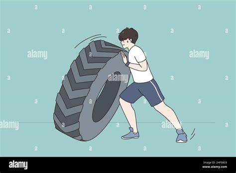 Young Sportsman Push Tire Do Workout Exercise In Gym Toned Strong Man