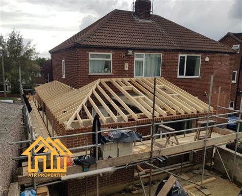 A House Being Built With Wooden Framing On The Front And Side Of It