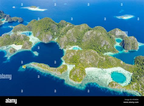 Aerial View Of A Remote Set Of Islands Surrounded By Beautiful Coral