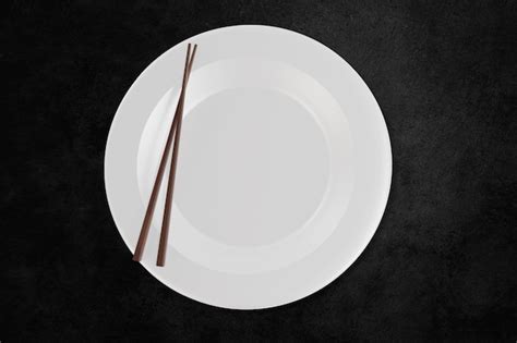 Premium Photo Image Of A White Plate With Chopsticks On The Plate