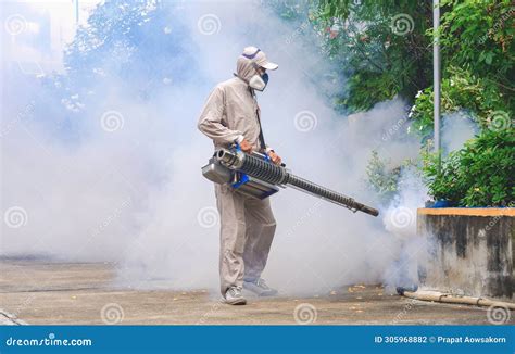 Outdoor Healthcare Worker Spraying Chemical To Eliminate Mosquitoes In Overgrown Area At General