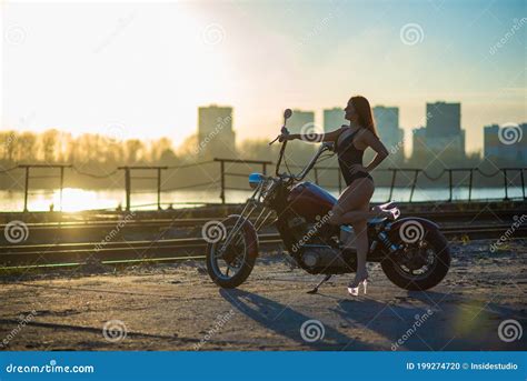Red Haired Woman In Lingerie In High Heels Sits On A Motorcycle Stock