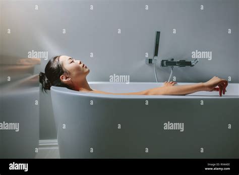 Young Woman Relaxing In Bathtub Asian Female Lying In Bathtub Stock