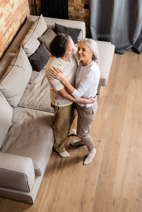 Overhead View Of Happy Middle Aged Couple Holding Hands While Dancing