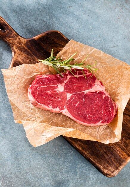 Premium Photo Fresh Raw Rib Eye Steak On Wooden Cutting Board With