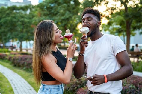 Premium Photo Afroamerican Man And A Latina Woman Sharing A Cone Of