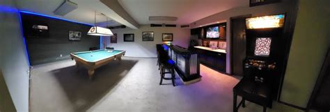 A Room That Has A Pool Table In It And Some Chairs Around The Bar Area