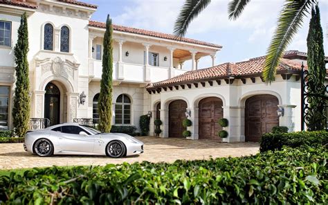 Download A White Sports Car Parked In Front Of A Mansion | Wallpapers.com