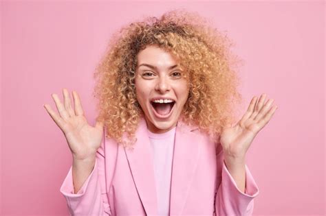 Free Photo Outraged Mad Young Woman With Curly Hair Screams Loudly