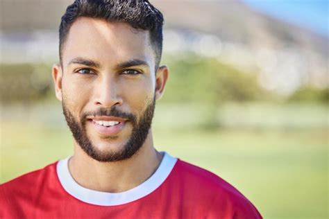 O Retrato Do Jogador De Futebol E O Homem No Campo De Futebol Sorriem