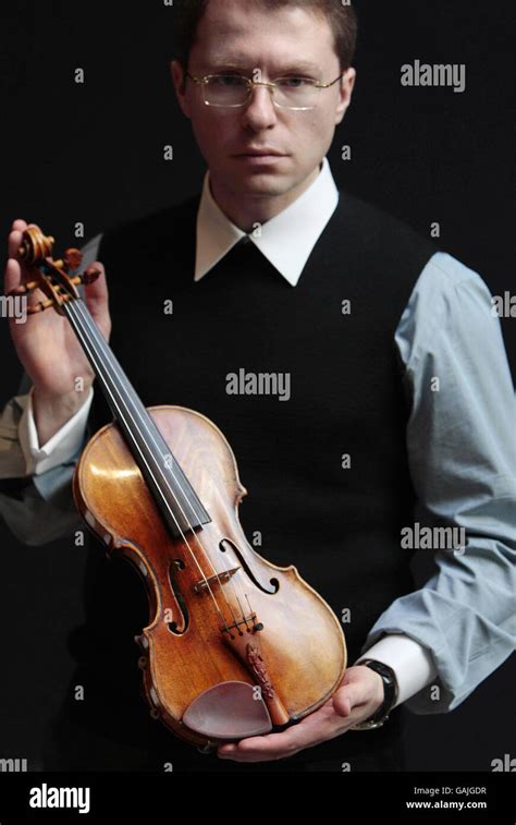 Russian businessman Maxim Viktorov holds a Guarneri del Gesu violin was ...