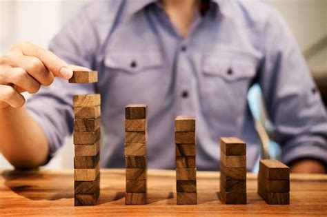 Premium Photo Midsection Of Man Stacking Wooden Toy Blocks At Table