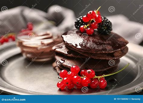 Delicious Chocolate Pancakes Decorated With Berries And Sweet Syrup On