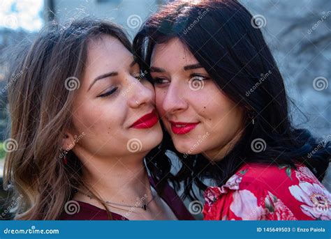 Close Up Of Two Lesbian Friends With Their Cheeks Resting One Blonde