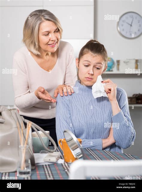 Mature Mother Soothes Adult Daughter Stock Photo Alamy