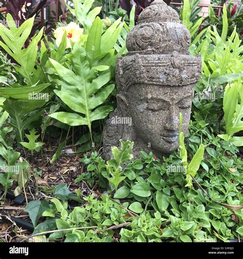 Garden sculpture face Stock Photo - Alamy