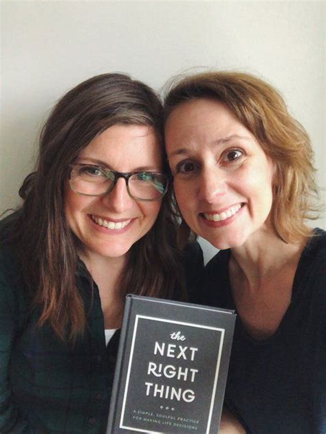 Two Women Are Posing For The Camera With A Book In Front Of Their Face