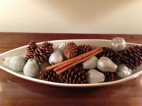 Bowl Filled With Pine Cones Cinnamon Sticks And Glittered Pears