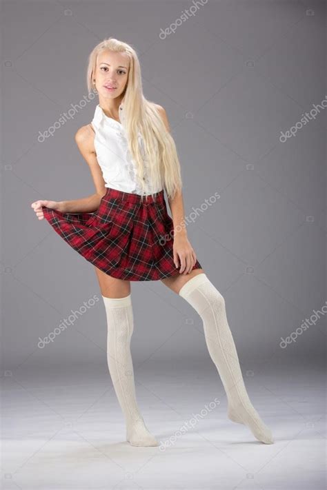 Stylish Fashionable Blonde Woman In White Shirt And Plaid Skirt Stock