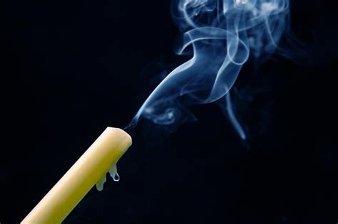 Premium Photo Smoke From An Extinguished Candle On A Dark Background