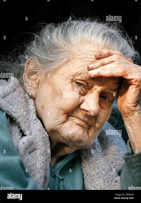 Old Woman Portrait Of A Very Old And Tired Of Life Wrinkled Woman Outdoors With A Hand Near Her