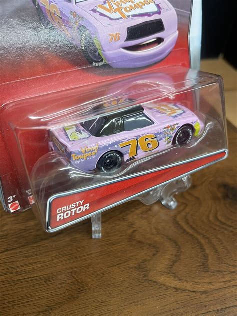 Disney Pixar Cars Crusty Rotor Vinyl Toupee Piston Cup Edition