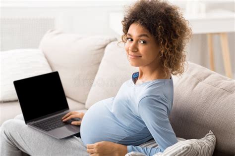 Expectant Woman Having Contractions And Doing Breathing Exercises Stock