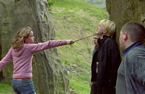 Hermione with wand pointed at Draco — Harry Potter Fan Zone