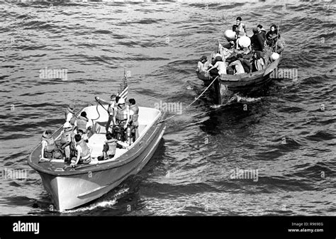 A life boat from the USS BLUE RIDGE (LCC 19) tows a Vietnamese fishing boat to the amphibious ...