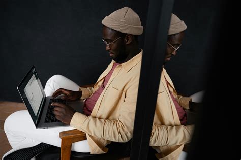 Focused Black Man Typing On Laptop · Free Stock Photo