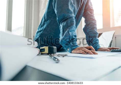 Engineers Pointing Building On Blueprint Using Stock Photo 1408133633