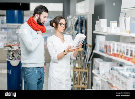 Pharmacist With Client In The Pharmacy Store Stock Photo Alamy